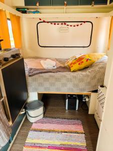 a small room with a bed in a rv at Camper Somá in Muonio