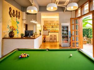 a pool table in a room with a bar at Yangshuo Eden's Social Guesthouse - cozy garden courtyard & fresh craft coffee & night beers & outdoor activities in Yangshuo +119 photos