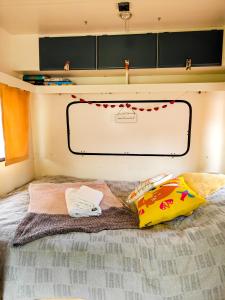 a bed with two pillows on top of it at Camper Somá in Muonio +17 photos
