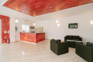 a living room with couches and a table and a kitchen at Hotel Alexandros in Ammoudia +76 photos