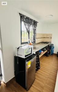 a kitchen with a microwave on top of a table at Apartamento La bonita guatape in Guatapé