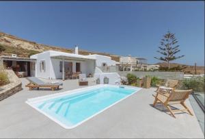 a swimming pool in front of a villa at Morning glow villa in Antiparos