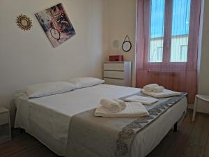 a bedroom with a bed with towels on it at MaGi-A apartment in Cecina