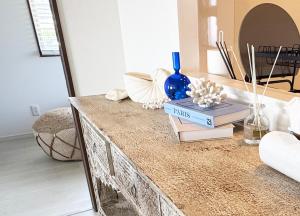 a table with books and vases on top of it at Maison deLacue in Uruma +74 photos