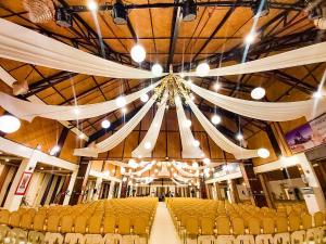 a large room with yellow chairs and a large ceiling at Paradise Garden Hotel and Convention Center Boracay Powered by ASTON in Boracay