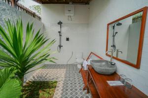 a bathroom with a sink and a potted plant at Villa Kebun Pala in Borobudur +13 photos