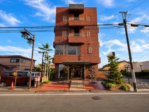 a tall brick building on the corner of a street at 和洲館ホテル in Gyōda