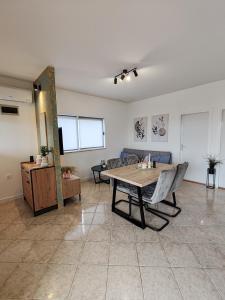 a living room with a table and a couch at Holiday home Tcono in Tkon +36 photos