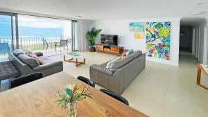 a living room with a couch and a table at Majorca Isle Beachside Resort in Maroochydore