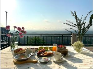 a table with food and drinks on a balcony at Tsuya Hill Private Mountain View Villa, Chiang Rai in Mae Chan