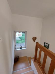 a room with a staircase and a window at Penzión Ostrva in Vyšné Hágy