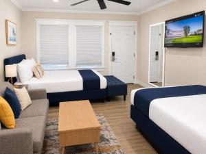 a hotel room with two beds and a couch at Coronado Inn in San Diego +63 photos
