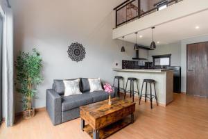 a living room with a couch and a table at Iris Apartment in Dalung