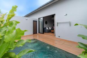 a house with a swimming pool in the middle of a yard at Iris Apartment in Dalung