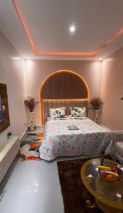 a bedroom with a large bed and a table at Casa résidences in Bouaké