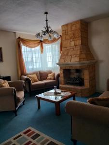 a living room with a couch and a fireplace at House in a private gated community in Chihuahua