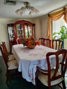 a dining room table with a basket of oranges on it at House in a private gated community in Chihuahua +26 photos