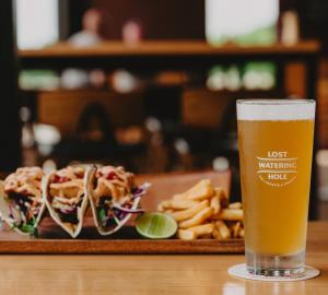 a glass of beer next to a plate of food at Lancefield Guest House in Lance Field +15 photos