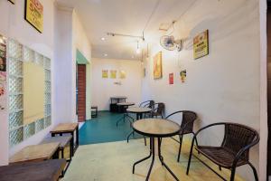 a group of tables and chairs in a room at RedDoorz at Taman Galaxy Bekasi in Bekasi