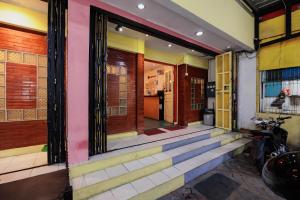 a building with colorful doors and stairs on it at RedDoorz at Taman Galaxy Bekasi in Bekasi