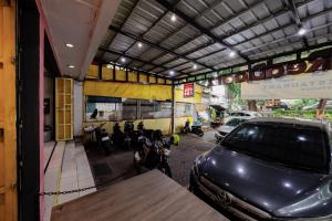 a car parked in front of a building at RedDoorz at Taman Galaxy Bekasi in Bekasi
