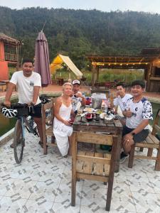 a group of people sitting around a table at Chamka Sne LyLy Resort in Phumĭ Stœ̆ng Chral