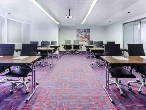 a classroom with desks and chairs in a room at ibis Styles Sharjah in Sharjah