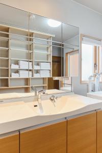 a bathroom with a sink and a mirror at 星宿 Sirius in Asahikawa +36 photos