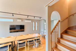 a dining room and kitchen with a table and chairs at 星宿 Sirius in Asahikawa