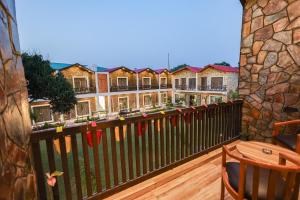a balcony view of a row of houses at Tiger Aura Resort in Rāmnagar