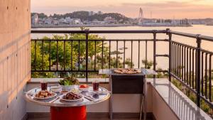 a table with plates of food on a balcony at Daebudo (Yeongheungdo) Dunia Spa Pension in Incheon