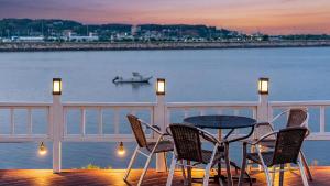 a table and chairs on a balcony overlooking the water at Daebudo (Yeongheungdo) Dunia Spa Pension in Incheon +2 photos