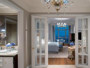 a bedroom with a large bed and a chandelier at Sofitel Foshan Shunde in Shunde