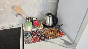 a counter top with a coffee pot and cookies at Danista Nomads Tour Hostel in Ulaanbaatar