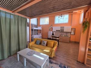 a living room with a couch and a table at Danista Nomads Tour Hostel in Ulaanbaatar