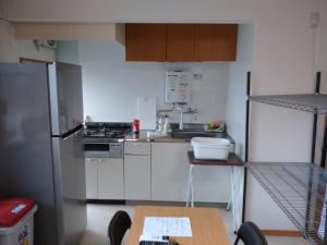 a small kitchen with white appliances and a table at Hall D - Vacation STAY 14820 in Kōnosu