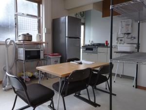 a kitchen with a table and chairs and a refrigerator at Hall D - Vacation STAY 14820 in Kōnosu