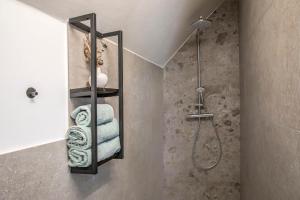 a bathroom with a shower with towels on a wall at Weingut Peter Grill in Leutschach +153 photos