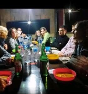 a group of people sitting around a table with bottles at Chepclean in Kelimutu +7 photos