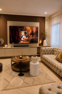 a living room with a couch and a table at The Luxury Orchid in Pietermaritzburg
