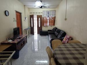 a living room with a couch and a table at Qc HOMESTAY JINTAN- Bukan Islam Pemilik in Pasir Mas