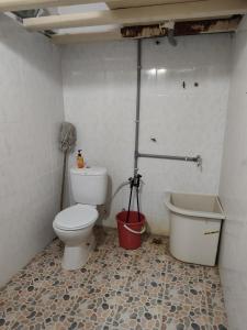 a bathroom with a toilet and a bath tub at Qc HOMESTAY JINTAN- Bukan Islam Pemilik in Pasir Mas +7 photos