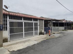 a building with a gate and a fire hydrant next to a street at Qc HOMESTAY JINTAN- Bukan Islam Pemilik in Pasir Mas