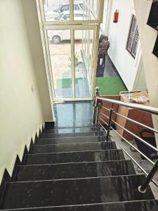 a staircase in a building with a window at Hotel Ram Shankar - Saryu Ghat in Ayodhya