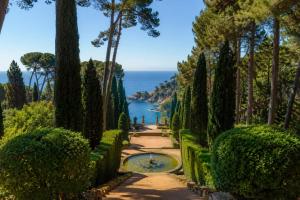 a path through a garden with a view of the ocean at Belice 1-6 in Lloret de Mar