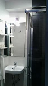 a bathroom with a shower and a sink at Hostal Campo de Estrelas in Santiago de Compostela
