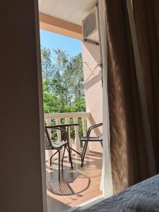 a room with a balcony with a table and chairs at Hotel Jacob in Ureki