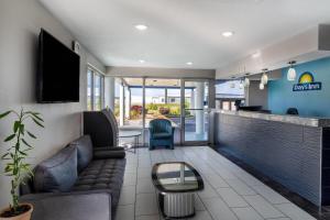 a living room with a couch and a table at Days Inn by Wyndham Greeneville in Greeneville