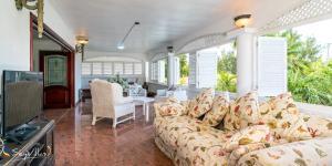 a living room with a couch and a table at Le Bonheur Villa in Victoria