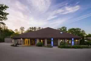 a building with blue lights on the front at Baymont by Wyndham Logan in Logan